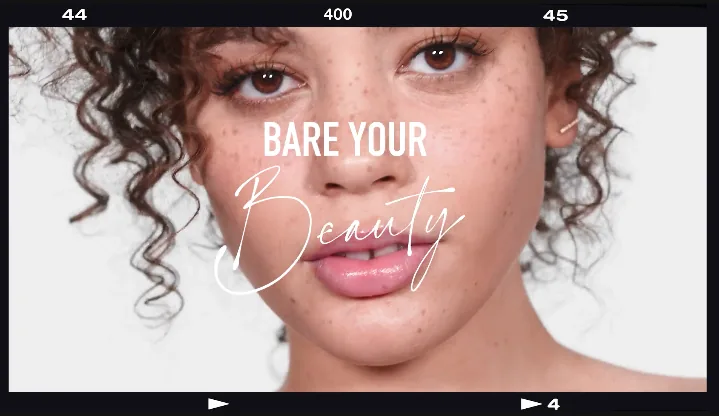 Film-strip frame of a bareMinerals video: close-up of a freckled model with the line Bare Your Beauty
