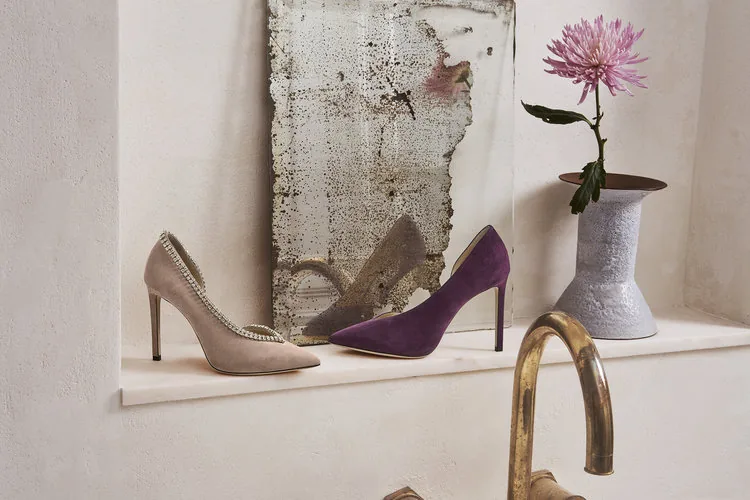 Jimmy Choo FW18 still life: a crystal-trimmed pump and a purple suede pump on a shelf, by Maxime Poiblanc