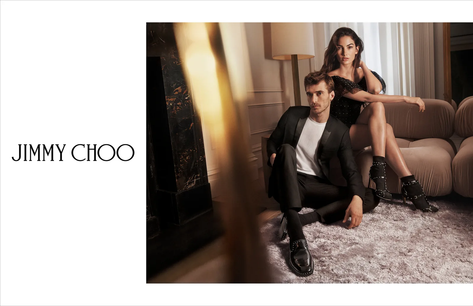 Jimmy Choo FW18 print ad layout: a man on the rug and Lily Aldridge on the sofa, with the wordmark