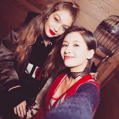 Selfie of Gigi Hadid in red lipstick with a fan, Tommy x Gigi tour