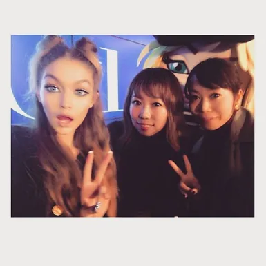 Polaroid of Gigi Hadid and two fans flashing peace signs, Tommy x Gigi tour