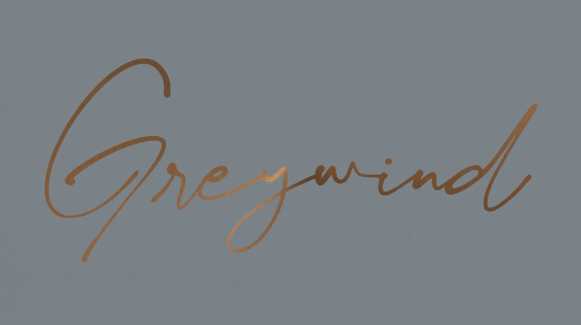 Greywind logo: the name in gold script on a grey field