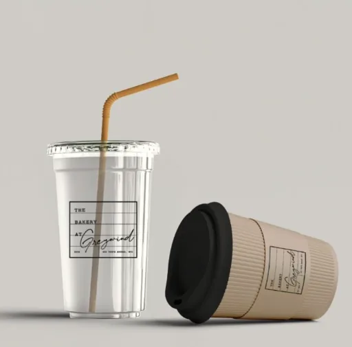 The Bakery at Greywind branded cups: an iced cup with a straw beside a ribbed coffee cup