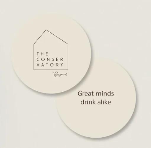 Round coasters for The Conservatory by Greywind, one reading Great minds drink alike
