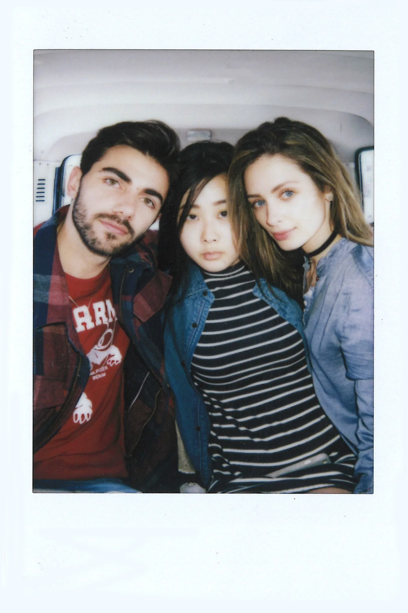 Polaroid of three friends in Tommy Jeans squeezed into the back of a car