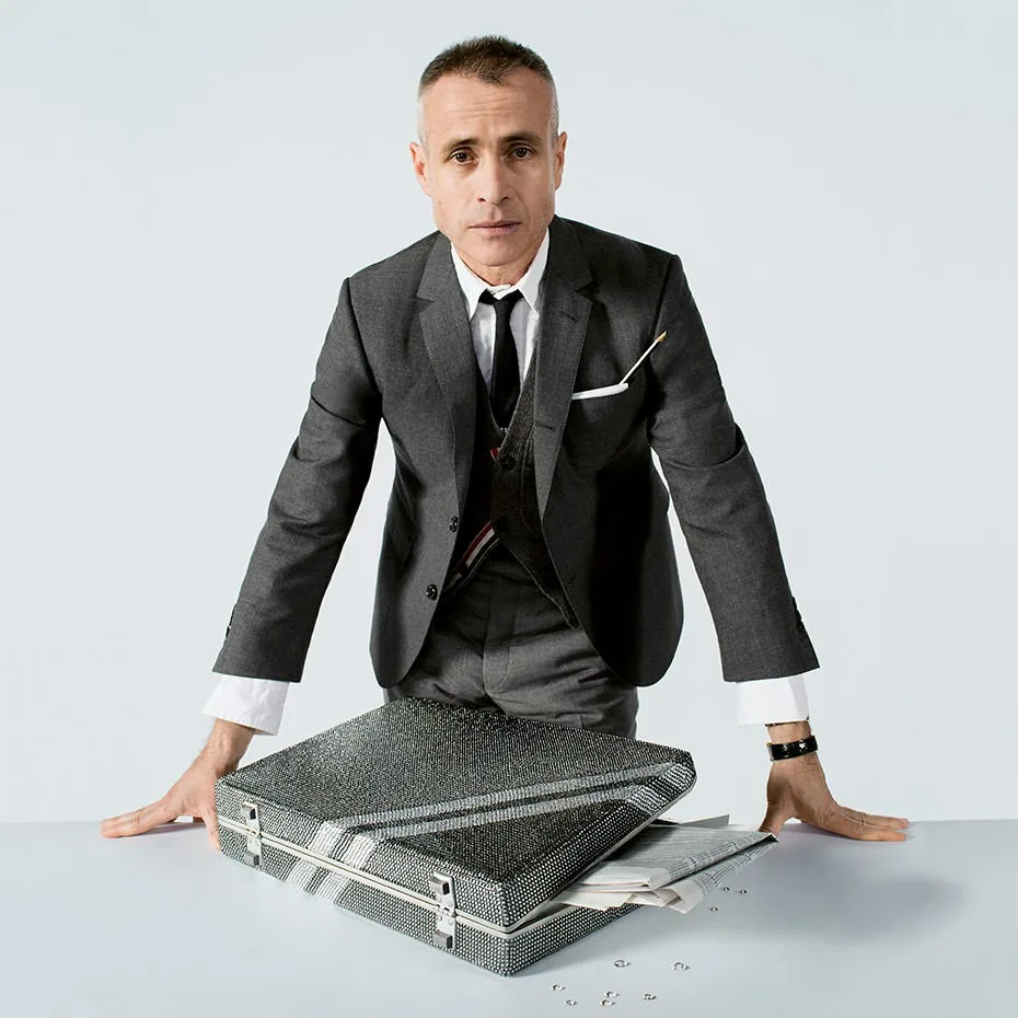Thom Browne in a grey suit behind a crystal-covered briefcase, Swarovski Brilliant Inspiration portrait