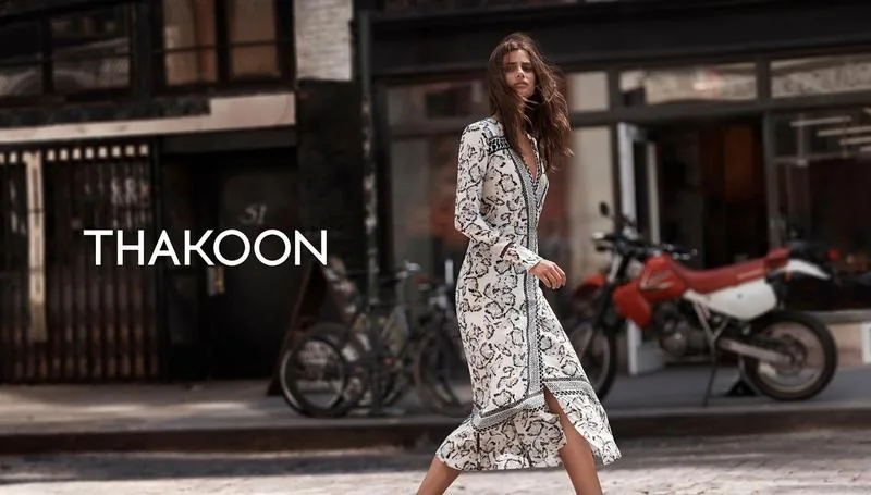 Thakoon Fall 16 campaign still: model in a printed wrap dress on a city street, with the Thakoon wordmark