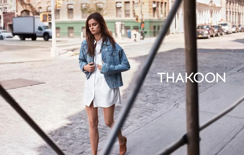Thakoon Fall 16 campaign still: model in a denim jacket over a white shirtdress on a Soho street