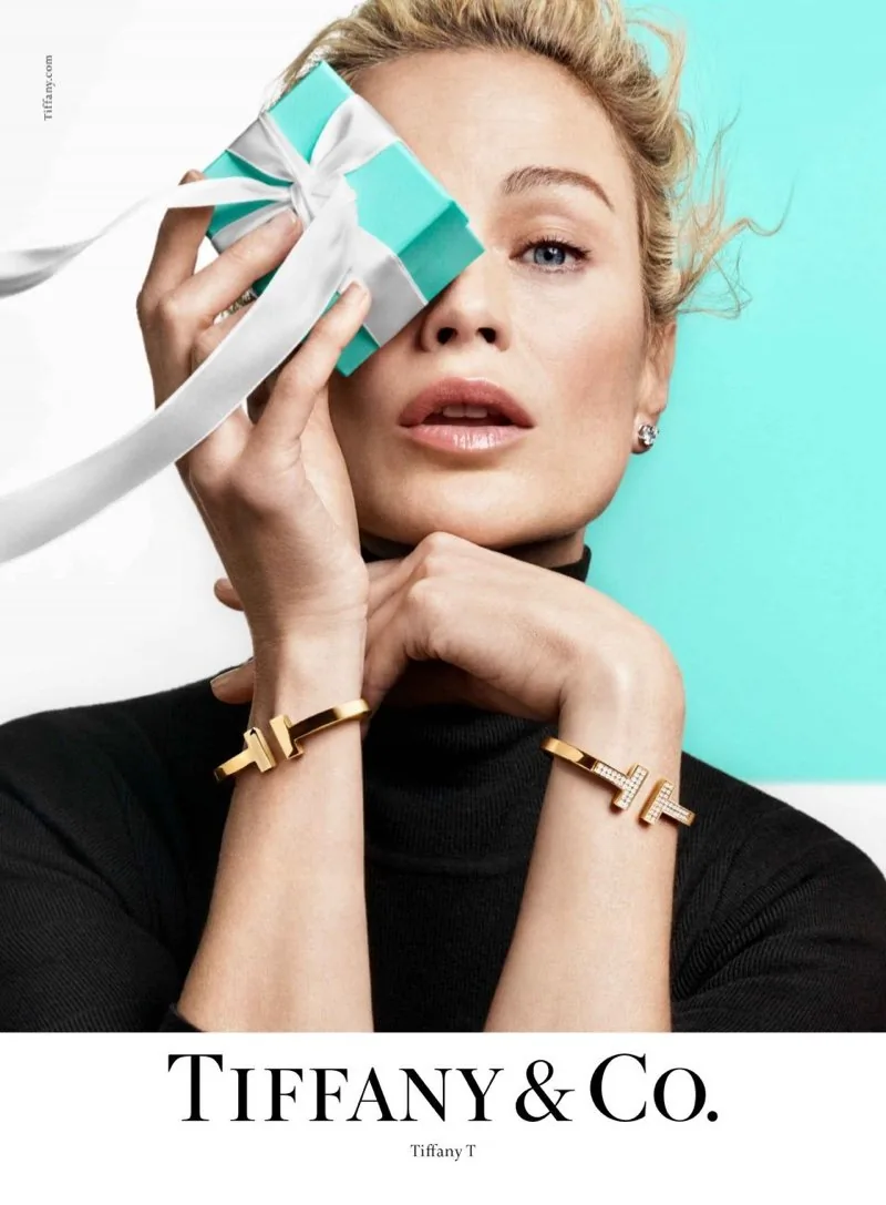 Tiffany T 2019 ad: a blonde model holds a Tiffany blue box lid over one eye, wearing T wire bracelets