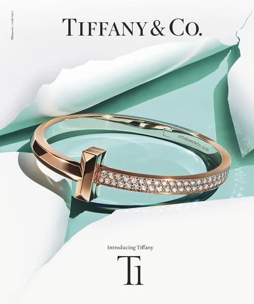 Introducing Tiffany T1 ad: a rose-gold pave T1 ring bursting through torn white paper over Tiffany blue