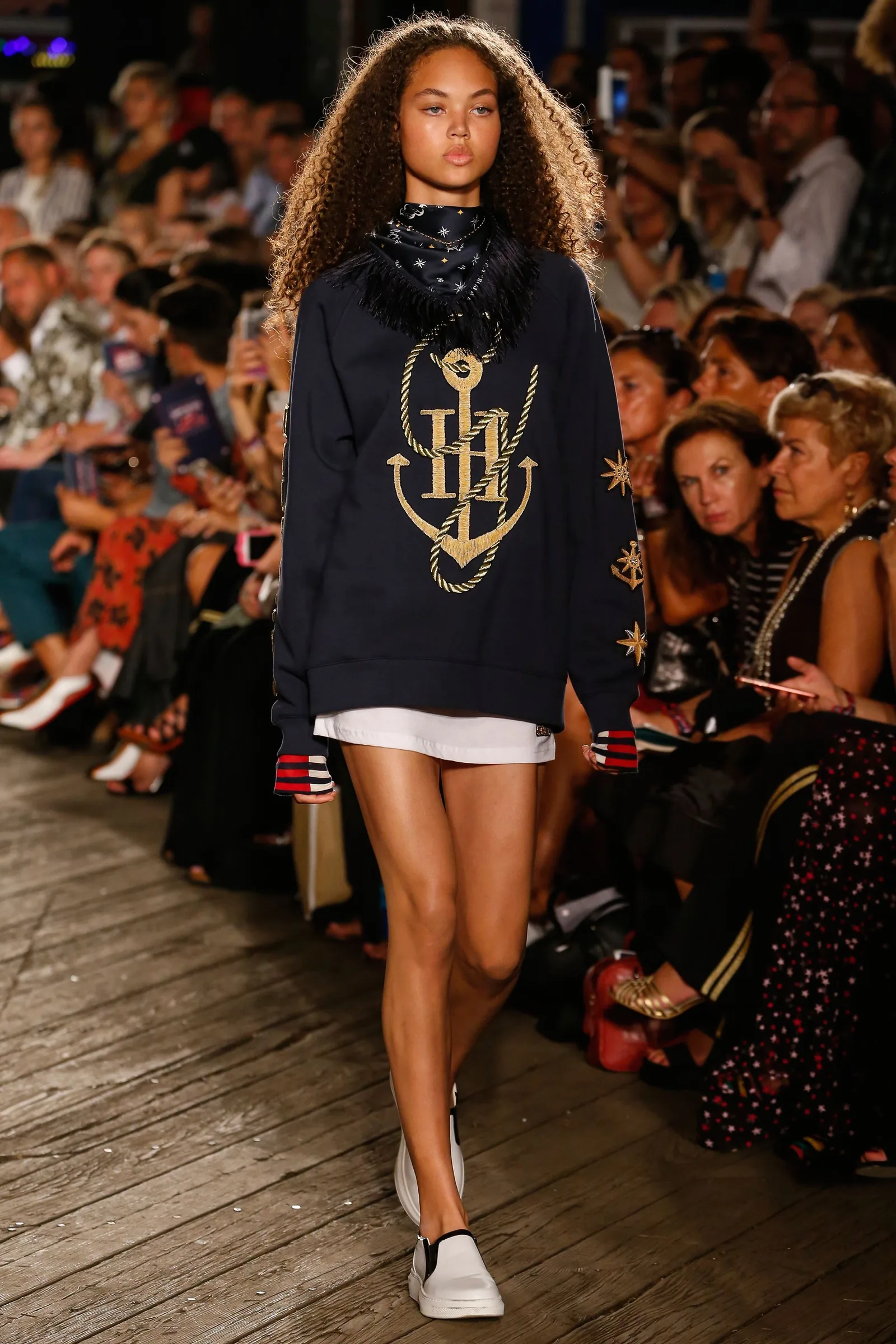 TommyNow runway look: a model in a navy anchor-logo sweatshirt dress