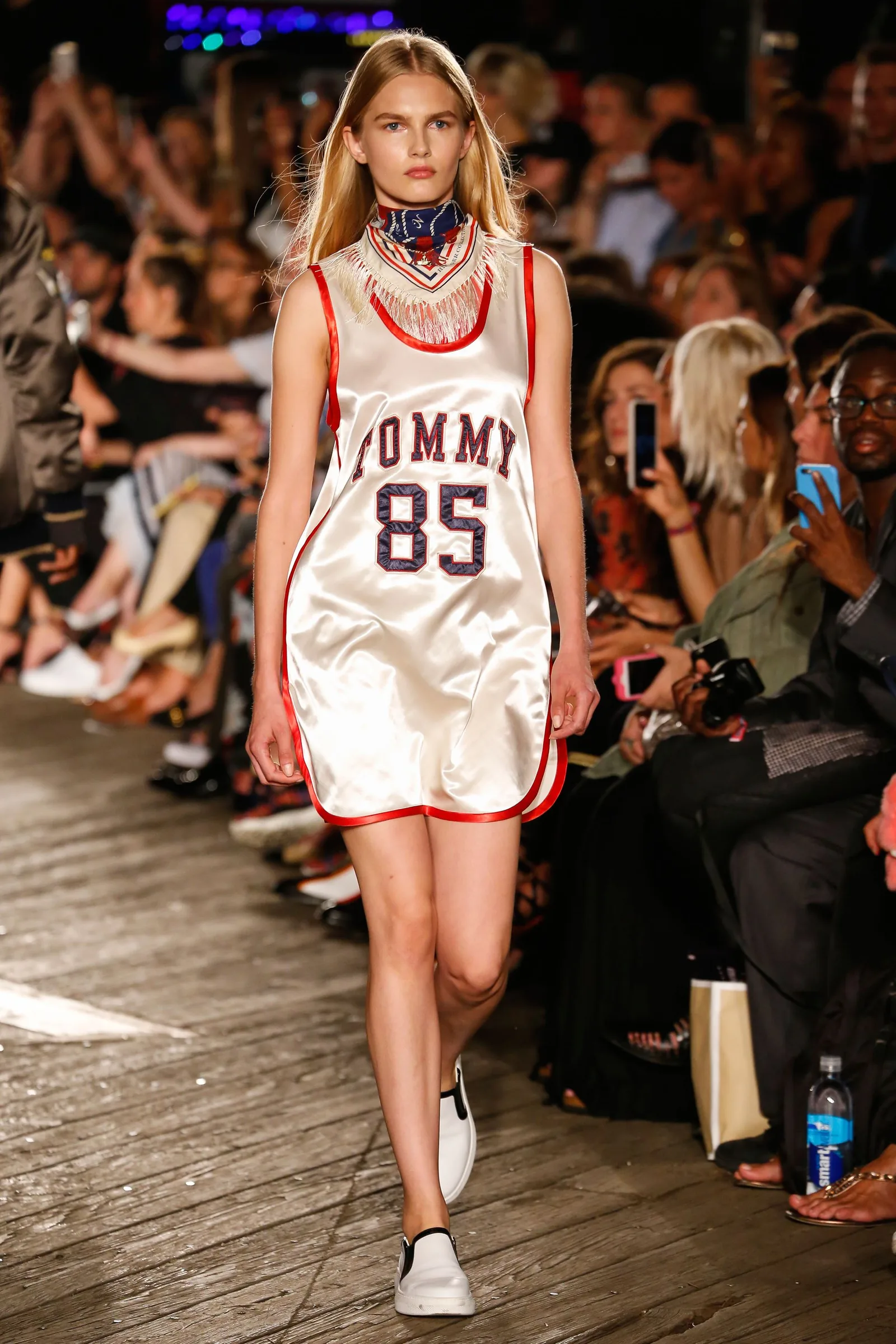 TommyNow runway look: a model in a white Tommy 85 satin jersey dress